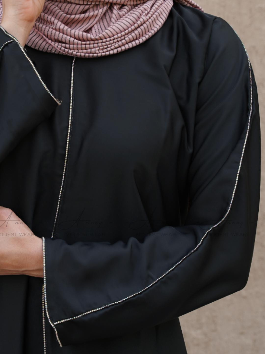 Modest black abaya featuring luxurious stone lace embellishments